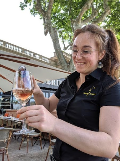 Waitress pouring wine on the patio of a popular restaurant in Carcassonne, France - photo by T.B.