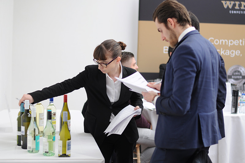 Judges looking at packaging details at the London Wine Competition